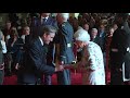 investiture archive tommy smith receives obe from her majesty queen elizabeth ii