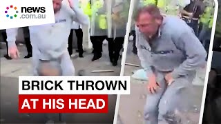 Violent protest sees UK man pelted with bricks