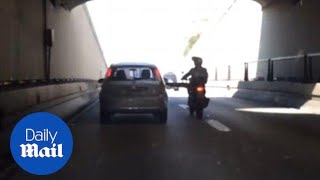 Motorcycle kicks car on the highway and immediately falls over