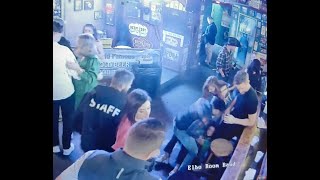 very intoxicated woman tumbles to the floor after making out at the bar.