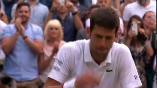 Novak Djokovic celebrates his Wimbledon championship win by eating the grass
