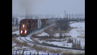 00063  4 CP Rail SD40-2's in Snow Storm Approaching an Uphill 'S' Curve in Throttle 8!! DeWinton, AB