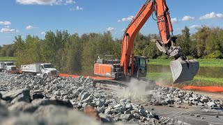 Zaxis 350 LC Excavator Stacking Rocks for Levee Protection