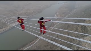 Workers Maintain World's Highest-voltage Power Line across Yellow River