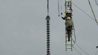 Helicopter removing a large insulator
