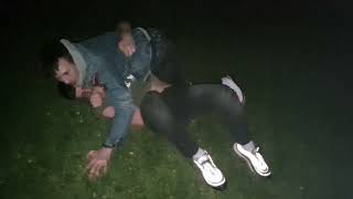 drunk white guys grapple in a park at night