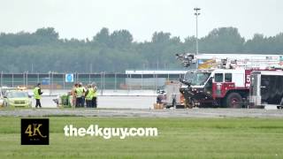 4K UHD - Airport crews with yellow vest standing near firetrucks