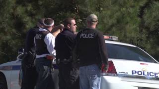 Bank robbery and man-hunt end with one dead, three arrested