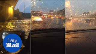 Driver ploughs through severe flooding on M25 after heavy rain - Daily Mail