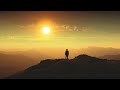 the man standing on a mountain top against a beautiful sunrise time lapse hd