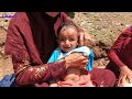 bathing an infant in the mountains nomad style iran nomad life