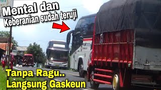 the bus overtakes the truck on an incline and it's almost a bullfight