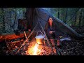 The girl is building a shelter in the forest.  Solo Bushcraft