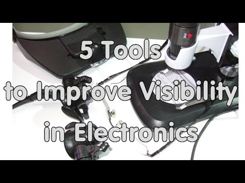 What tool do we use to magnify make larger and look at cell parts?