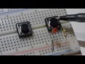 Normally open tactile push button switch. How to insert into breadboard and use in an LED circuit.