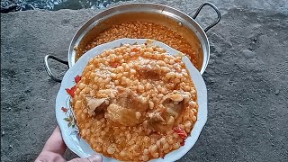 RICE PILAF WITH MEAT ON A WOOD FIRE IN THE VILLAGE.