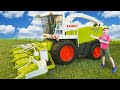 Combines harvesters Bruder Claas Jaguar 900 and Claas Lexion 480 working in the field