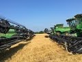 8 John Deere S690 Combines Harvesting Wheat