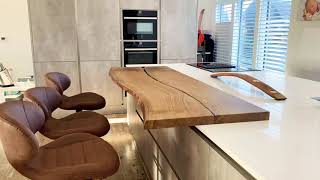 Waney edge wood slab breakfast bar by Earthy Timber. Luxury kitchen design