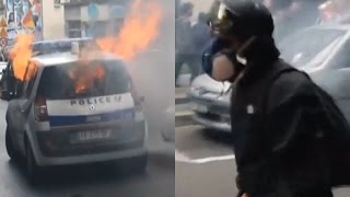 A French mob set an occupied police car ablaze