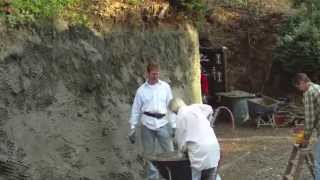 Plastering a mountain retaining wall.