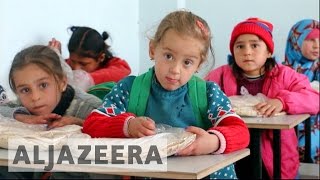 Children return to damaged schools in Syria