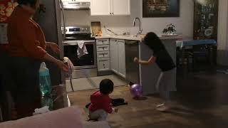 孩子很想参与，和人一起玩球。 5 year old child and 14 month old baby playing ball with grandma