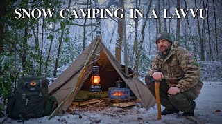 freezing cold uk wild camp - polish lavvu in a snow covered uk woodland