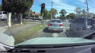 Idiot turning from wrong lane gets flashed by red light camera