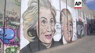 Picture politics adorn Israel's security wall