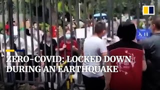Residents in China argue with guard to leave apartment blocks during deadly earthquake