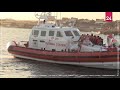 Italian coastguard with migrants from Banksy-funded rescue boat arrives at Lampedusa island