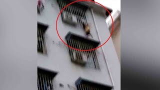 Boy rescued after dangling from window six stories up