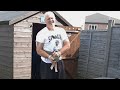 strong old man uses vintage weights to blast back in garden gym