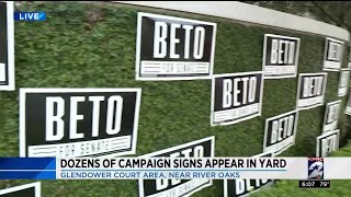 Dozens of campaign signs appear in yard