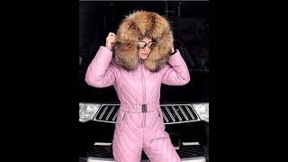 Gently pink women's ski jumpsuit with a huge fur trim. Warm women's walking overalls.