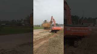 jcb bucket filling mud in heavy load truck