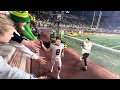 Dillon Gabriel shakes hands with Duck Fans at the Big House