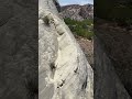 walking up a precarious sand stone ledges hogs back in the escalante grand staircase