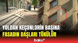 Bakıda binanın fasadının daşları camaatın başına tökülür | Təmir işləri gedir ki, tökülür...