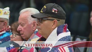 Veterans draped with quilts to honor their service this Veterans Day