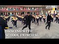 Chinese school principal teaches students shuffle dance during break