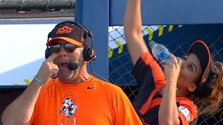 Oklahoma State softball player Raquel Dominguez video bombs coach by shotgunning water bottle