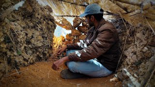 Cozy and comfort stone shelter between two rocks in the rain | bushcraft survival campaign