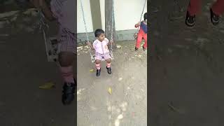 Little Prajwal is playing swinging at his school.