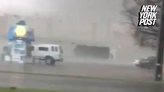 Massive tornado tosses a truck across a parking lot