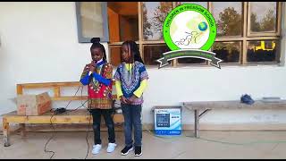 Wanja and Wambui present a shairi (poem in Swahili), 'Shule yetu yapendeza' (Our school is lovely)