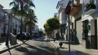 Driving through the main street of Manilva, Andalucia Spain