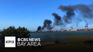 Fire near Port of Oakland spreads dark smoke plume along the bay