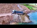 what happened in this plan expert truck unloading rock soils into deep water pushing by dozer d31a